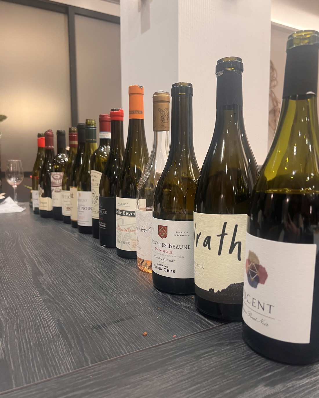 A Savigny-l&egrave;s-Beaune Monopole leading a long lineup of Burgundy and California bottles.
